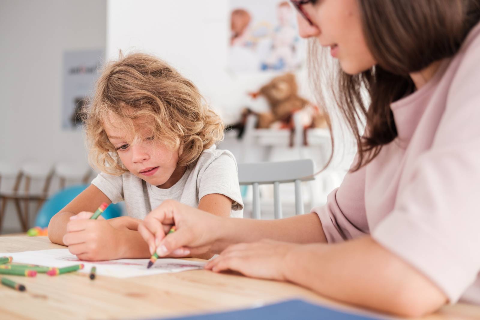 Teacher and child drawing together