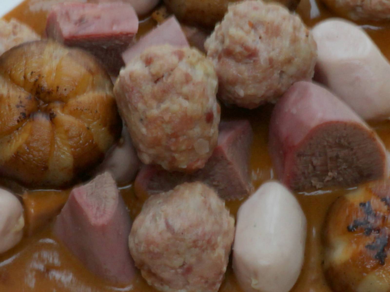 Teller mit Fleischstücken, Fleischkklößen und Soße