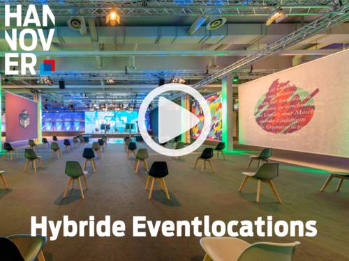 Modern, colorfully lit event room with individual chairs, large screen and creative wall design.