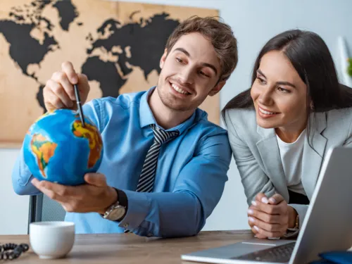 Two people with a small globe