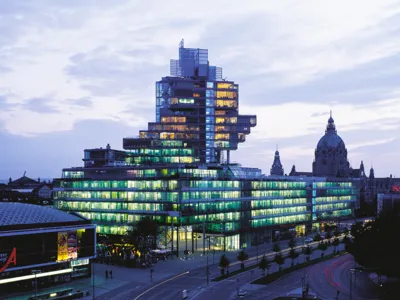 A large glass building at night.