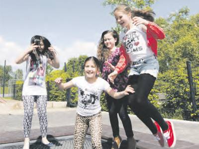 Vier Mädchen, die in die Luft springen. 