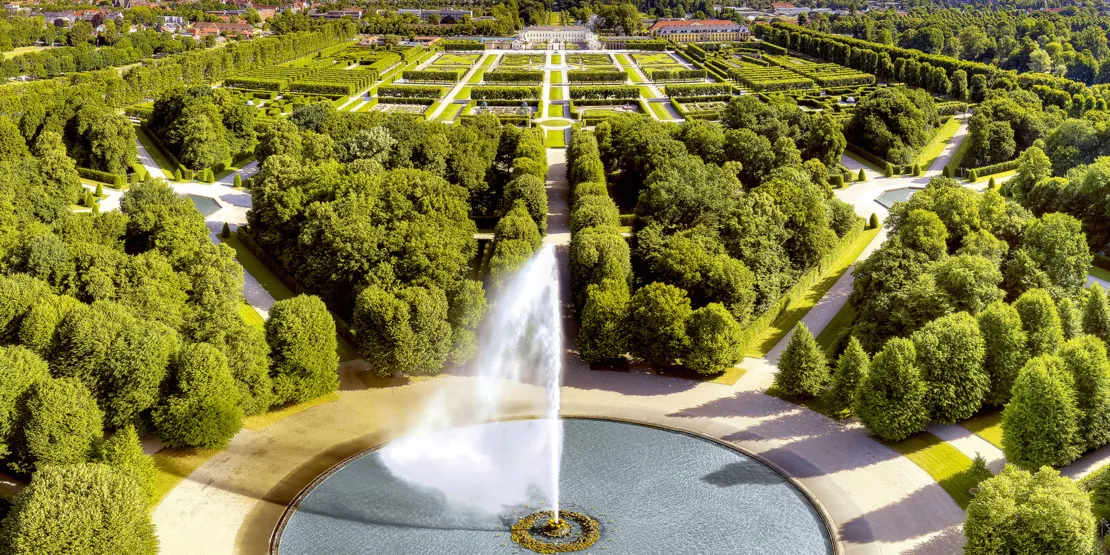 Her kan du se et dronebillede af det store springvand i Herrenhausen-haven med udsigt til Herrnhausen-slottet.
