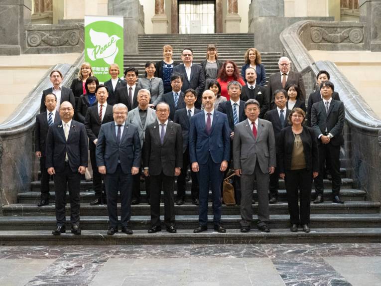 A delegation on a staircase.