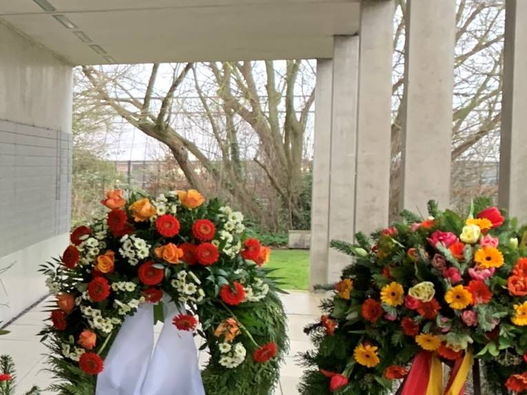 Kränze vor der Wand der Namen.