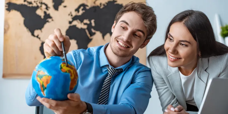 Two people with a small globe