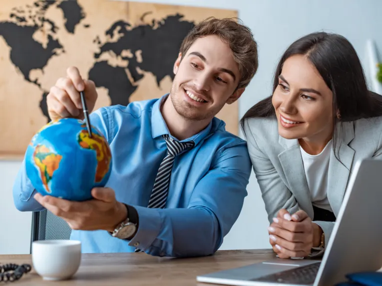 Two people with a small globe