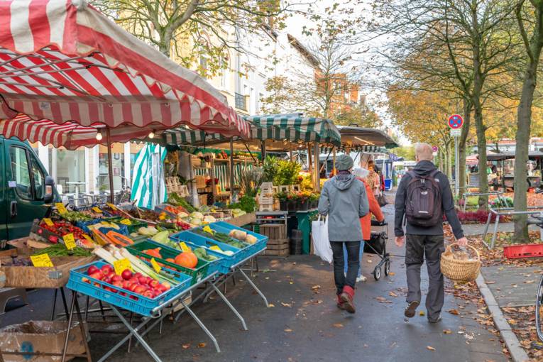 Kundschaft l&auml;uft zwischen den Wochenmarkt-St&auml;nden.