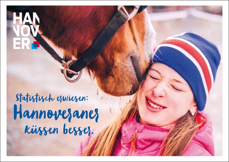 A horse kisses a woman.