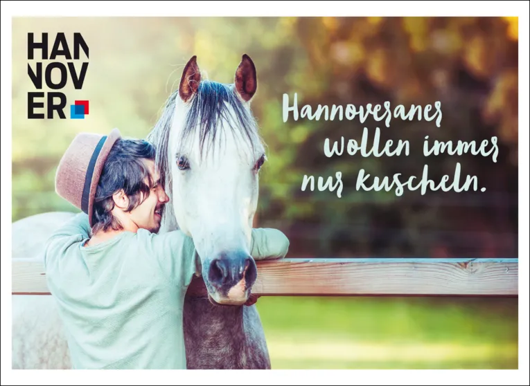 A man is hugging a horse.