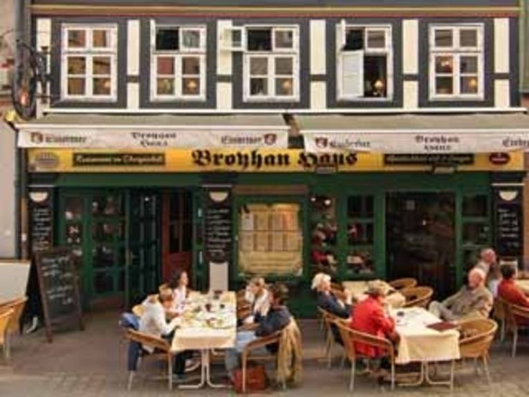 Vor dem Broyhan Haus sitzen Gäste.