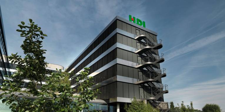 Auf einem modernen Bürogebäude sind die Buchstaben HDI zu sehen.