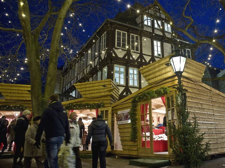 Finnish vendors sell handicrafts in wooden huts at the Christmas market