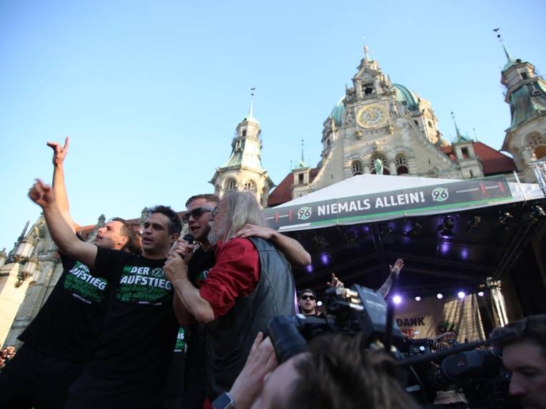 Menschen vor und in einem Rathaus. 