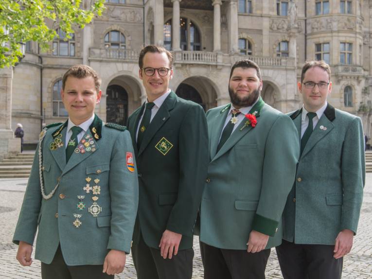 Vier Männer auf einem Platz. 