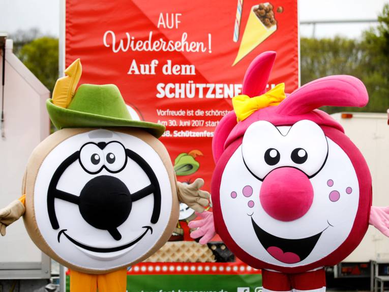 Zwei Maskottchen in Form einer kleinen Zielscheibe. 